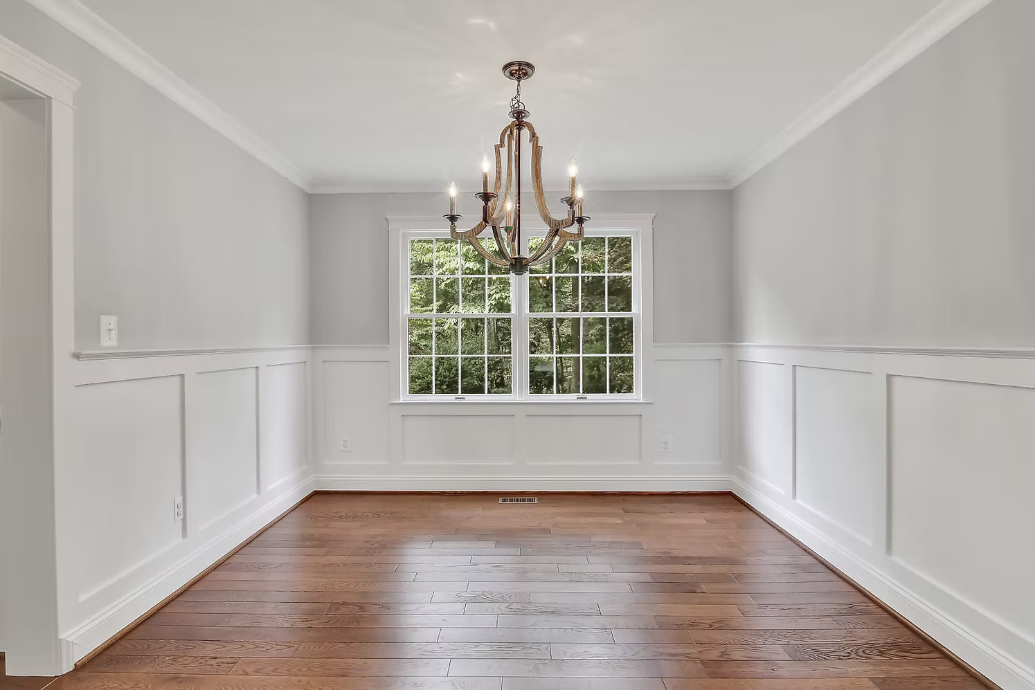 Formal dining room with wainscoting and chandelier