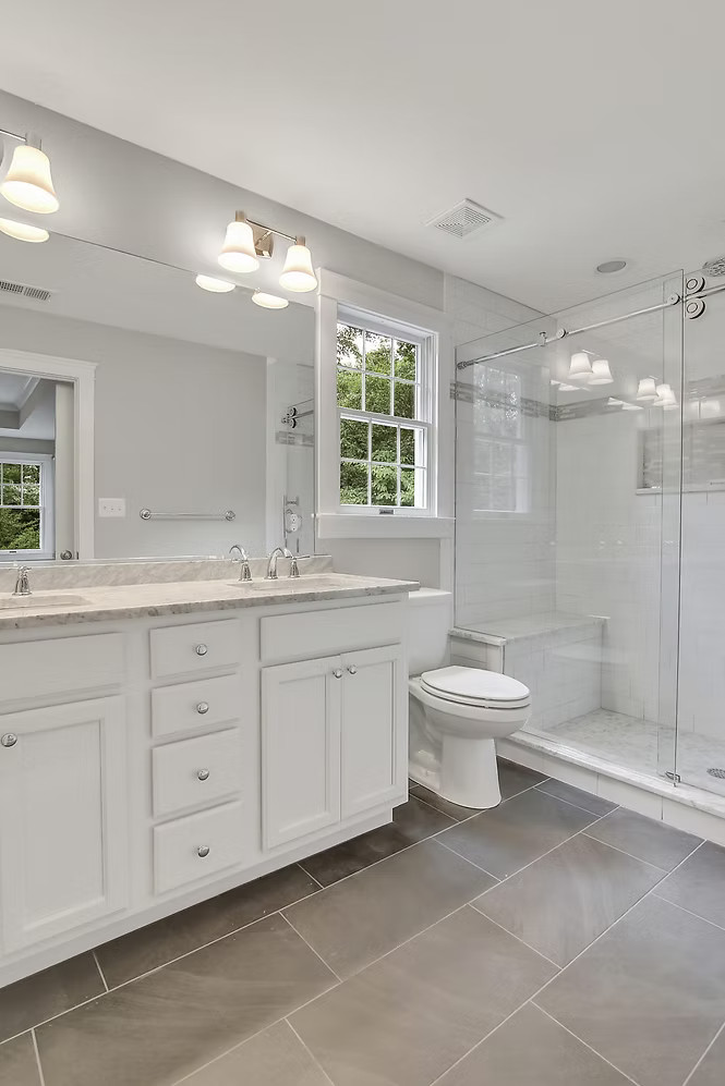 Full bathroom with double vanity and glass shower