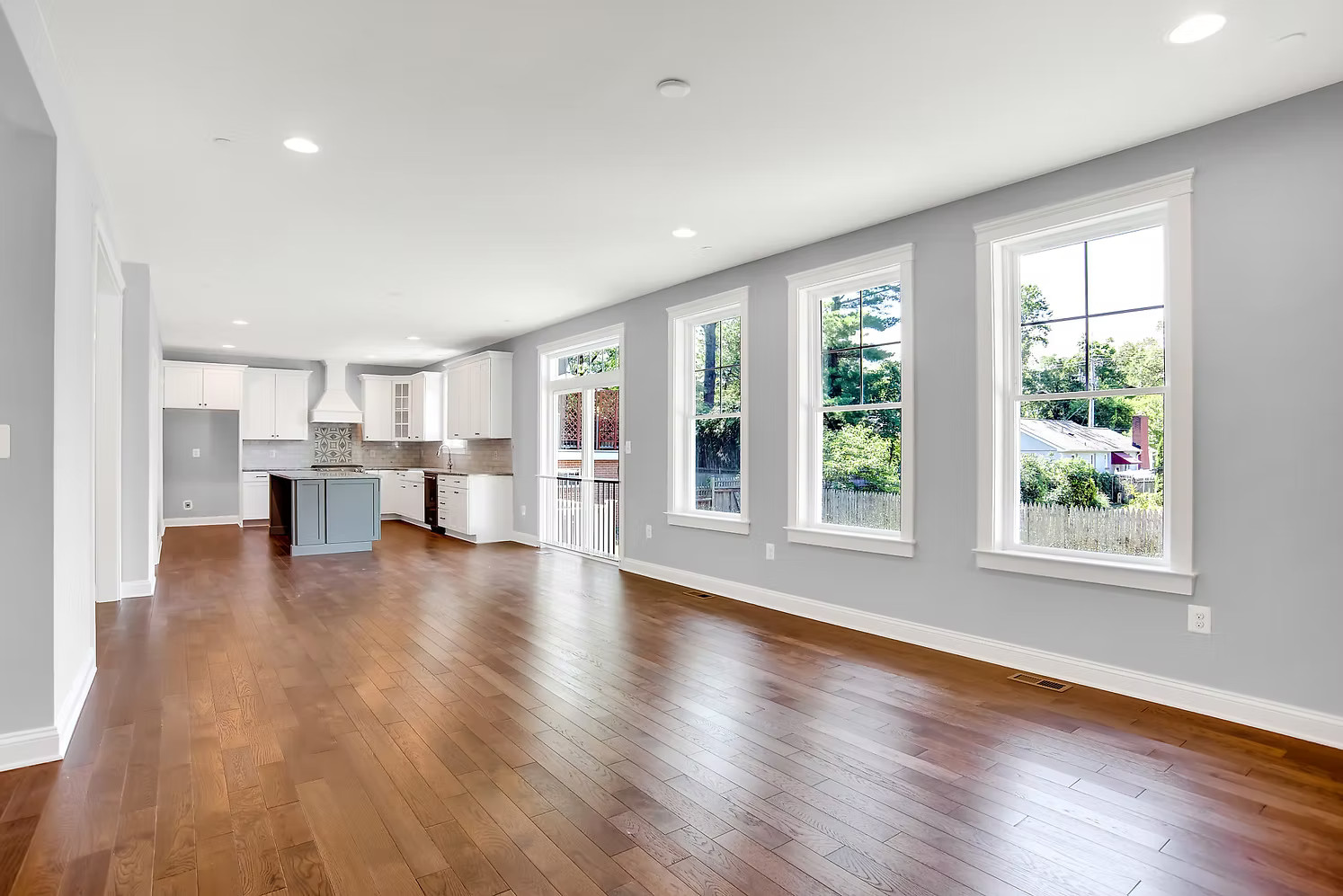 Interior of a custom home built by Choice Builders - open great room with hardwood floors and large windows